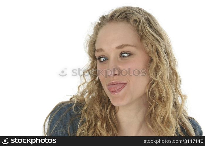 Beautiful blond girl sticking out her tongue and crossing her eyes. Shot with Canon 20D.