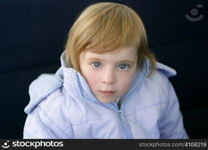 Beautiful blond toddler little girl with blue winter coat