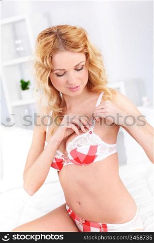 Beautiful blond woman adjusting underwear
