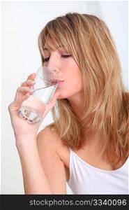 Beautiful blond woman drinking water
