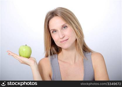 Beautiful blond woman eating green apple