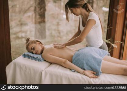 Beautiful blond woman enjoying a massage at the health spa