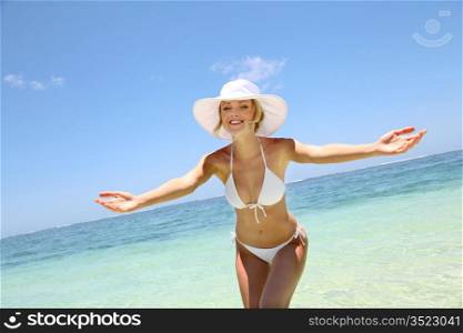 Beautiful blond woman in bikini by blue lagoon
