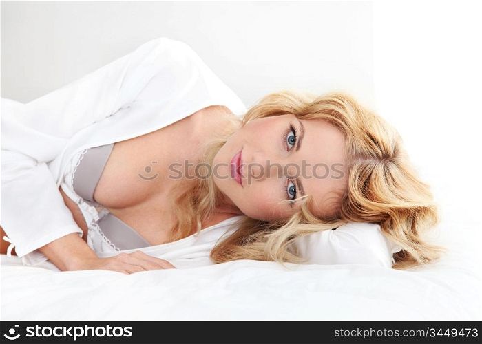 Beautiful blond woman in underwear laying on bed