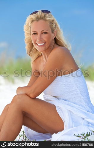 Beautiful Blond Woman in White Dress At Beach