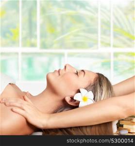 Beautiful blond woman lying down on massage table in spa salon, enjoying facial massage, doing facial mask, healthy lifestyle and beauty treatment concept