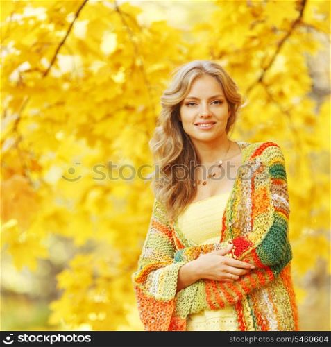 Beautiful blond woman posing in autumn park
