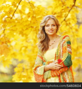 Beautiful blond woman posing in autumn park