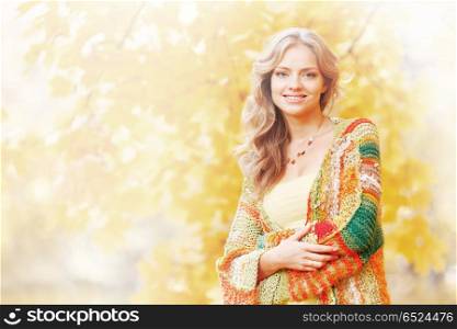 Beautiful blond woman posing in autumn park. Autumn woman