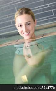 Beautiful blond woman relaxing in spa pool