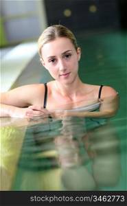 Beautiful blond woman relaxing in spa pool