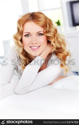 Beautiful blond woman relaxing on sofa