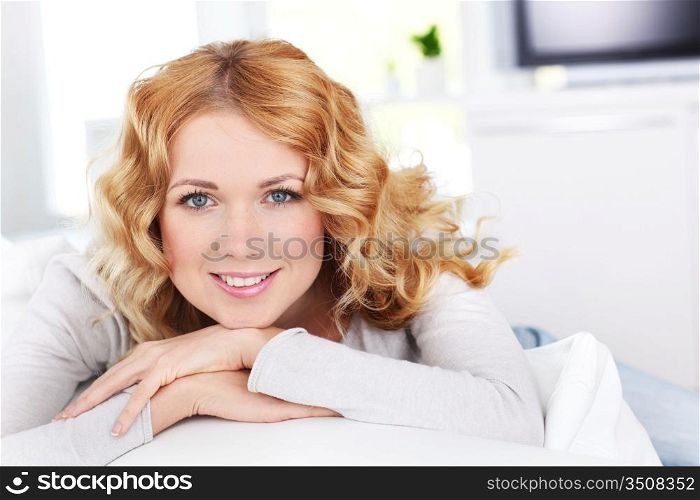 Beautiful blond woman relaxing on sofa