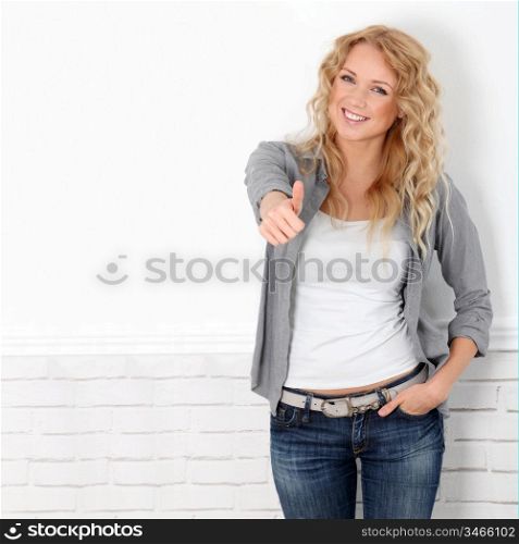 Beautiful blond woman showing thumb up