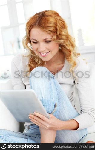 Beautiful blond woman using electronic tablet