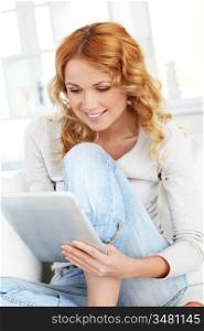 Beautiful blond woman using electronic tablet