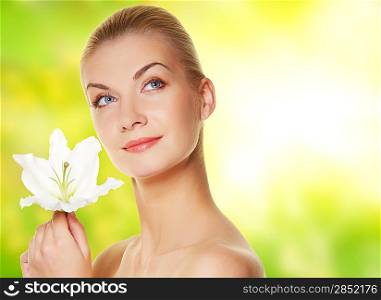 Beautiful blond woman with lily flower