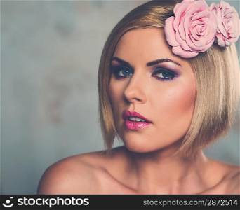 Beautiful blond woman with rosebud