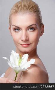 Beautiful blond woman with white lily flower