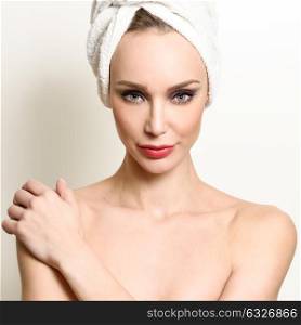 Beautiful blond woman with white towel on her head. Young girl with blue eyes and red lips.