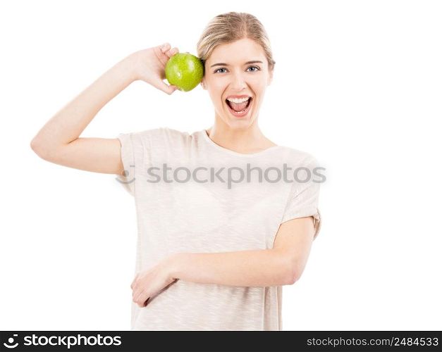 Beautiful blonde girl holding a green apple, isolated over a white background