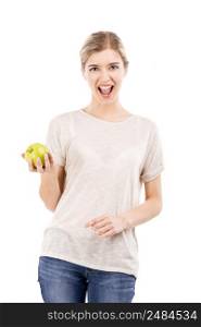Beautiful blonde girl holding a green apple, isolated over a white background