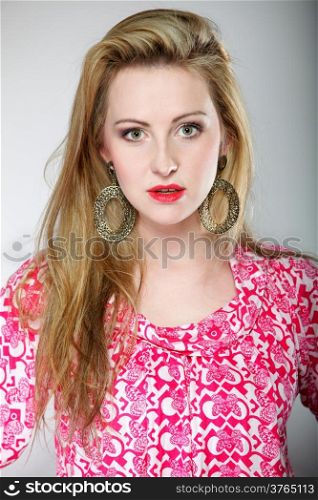 Beautiful blonde girl in summer clothes . Studio shot gray background