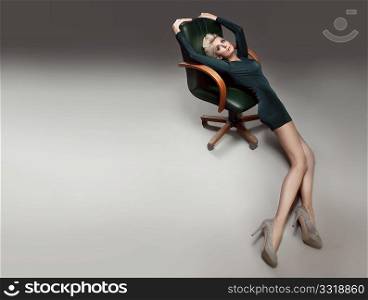 Beautiful blonde girl on the chair