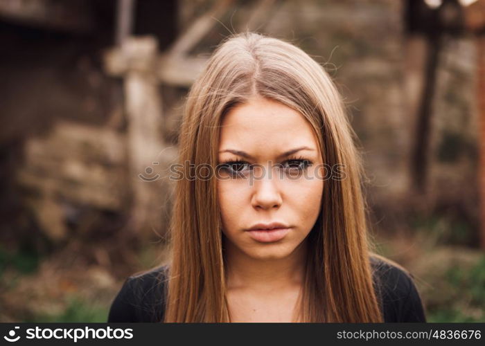 Beautiful blonde girl wih long hair and a sad expression