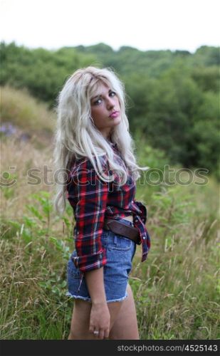 Beautiful blonde haired teenage girl looking straight to camera