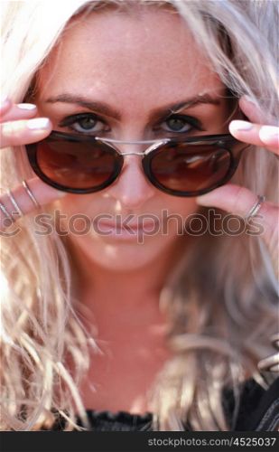 Beautiful blonde haired woman dressed in bohemian style at the beach