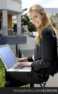beautiful blonde happy businesswoman with laptop computer