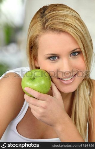 beautiful blonde woman and an apple