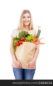 Beautiful blonde woman carrying a bag full of vegetables with thumbs up, isolated over white background