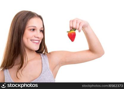 Beautiful blonde woman eating a fresh strawberry, isolated over white background