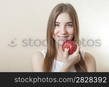 Beautiful blonde woman holding a red apple