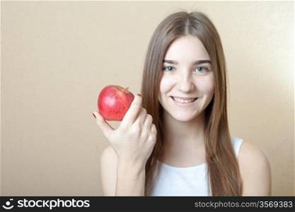 Beautiful blonde woman holding a red apple