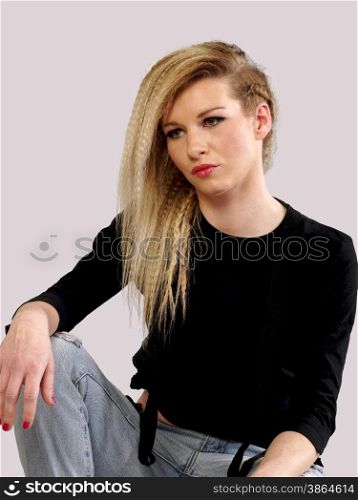 beautiful blonde woman in jeans posing, studio shot