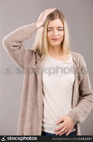 Beautiful blonde woman in pain with a big headache