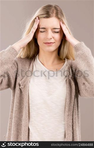 Beautiful blonde woman in pain with a big headache