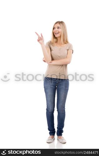 Beautiful blonde woman laughing and pointing to the right, isolated over white background