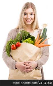 Beautiful blonde woman smiling and carrying a bag full of vegetables, isolated over white background