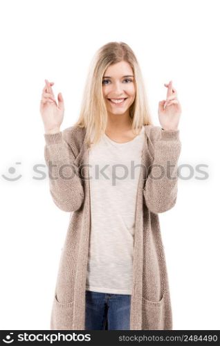 Beautiful blonde woman smiling and cross fingers, isolated over white background