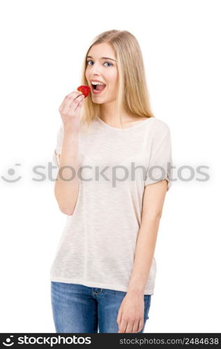 Beautiful blonde woman tasting a strawberrie, isolated over white background