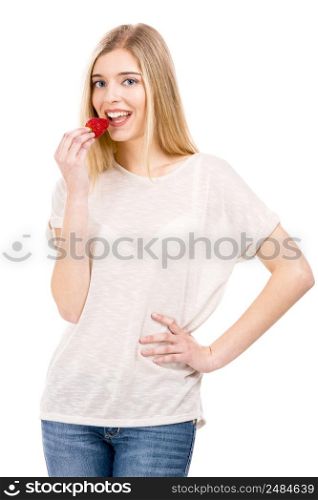 Beautiful blonde woman tasting a strawberrie, isolated over white background
