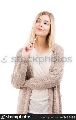 Beautiful blonde woman thinking while holding a pen, isolated over white background