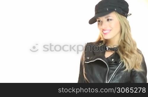 Beautiful blonde woman wearing a cap holds a handgun in her hands isolated on white