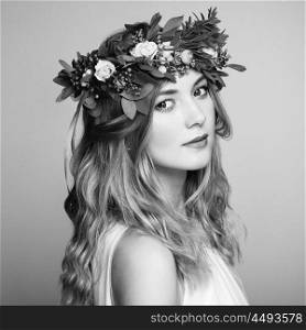 Beautiful blonde woman with flower wreath on her head. Beauty girl with flowers hairstyle. Perfect makeup. Beauty fashion. Spring woman. Black and White