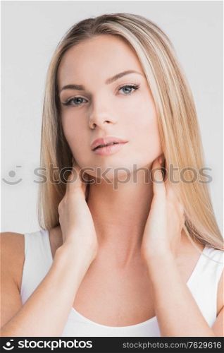Beautiful blonde woman with long straight hair on a white background beauty skincare concept. Beautiful woman with long hair