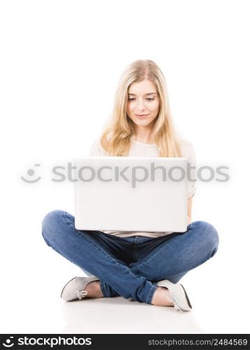 Beautiful blonde woman working with a laptop, isolated over white background